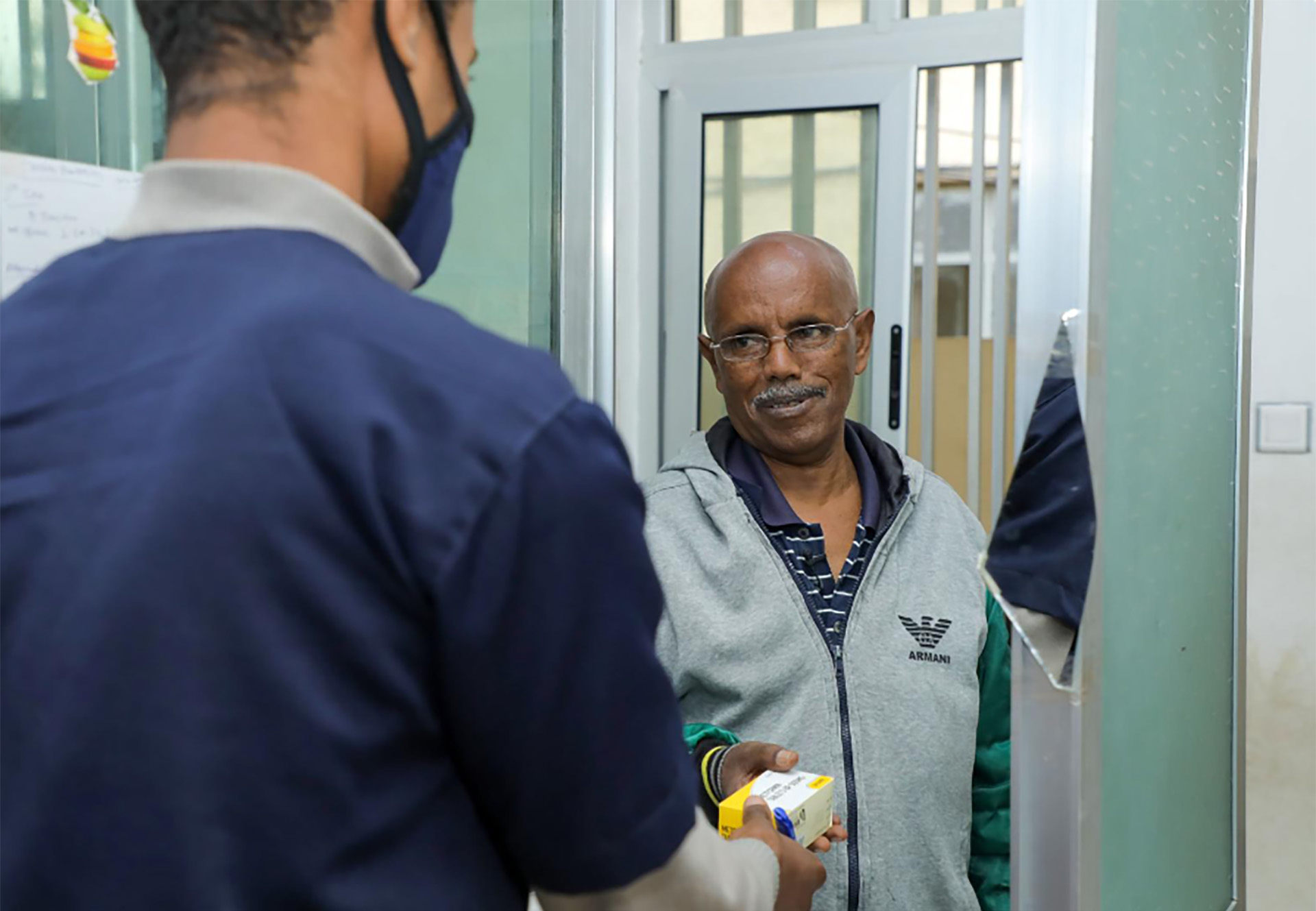 A health worker handing a package to a person