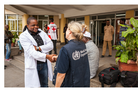 WHO staff and doctor shaking hands WHO staff and doctor shaking hands